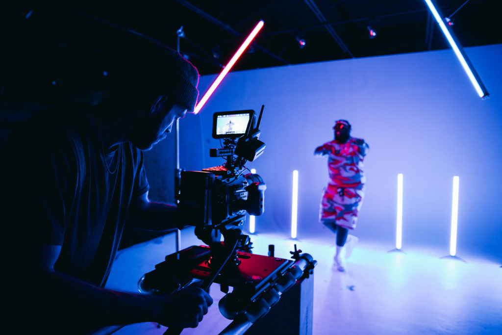 A videographer shooting video in a studio